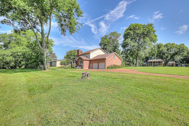 2010 Hartland Rd, Franklin, TN 37069 - view of grassy yard featuring an attached garage and driveway