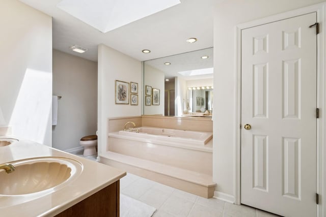 217 Fox Hunt Ln, Lebanon, TN 37087 - bathroom featuring a skylight, a bath, double vanity, tile patterned floors, and recessed lighting