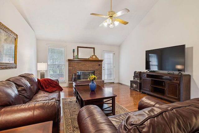 217 Fox Hunt Ln, Lebanon, TN 37087 - living room featuring wood finished floors, a ceiling fan, a fireplace, and high vaulted ceiling