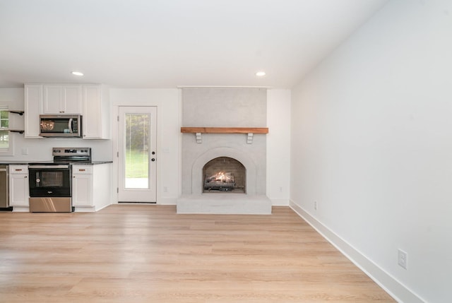 1026 Carthage Hwy, Lebanon, TN 37087 - unfurnished living room featuring a fireplace, light wood-style flooring, and recessed lighting