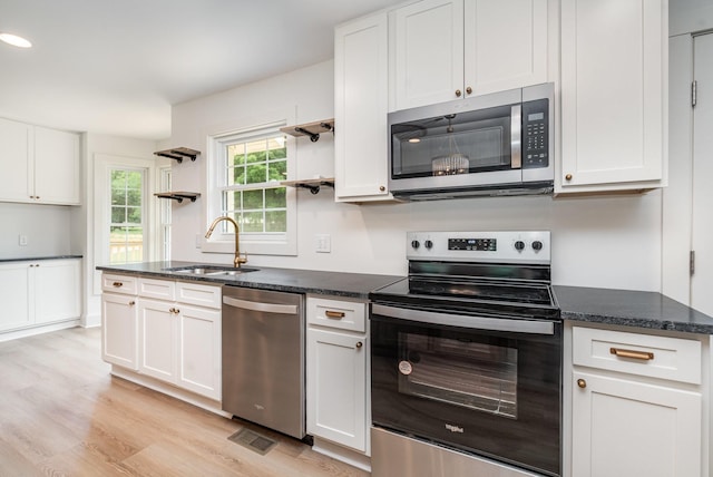 1026 Carthage Hwy, Lebanon, TN 37087 - kitchen with appliances with stainless steel finishes, open shelves, light wood-type flooring, white cabinets, and recessed lighting