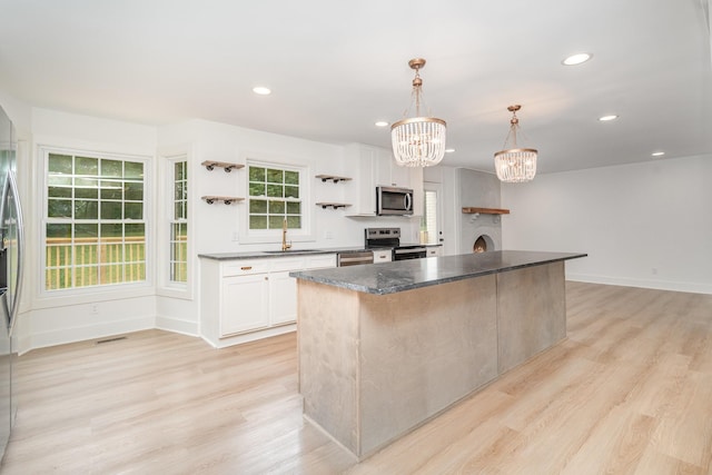 1026 Carthage Hwy, Lebanon, TN 37087 - kitchen featuring appliances with stainless steel finishes, open shelves, a chandelier, a kitchen island, and white cabinetry