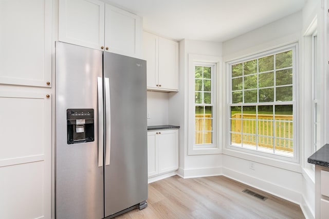 1026 Carthage Hwy, Lebanon, TN 37087 - kitchen featuring stainless steel fridge with ice dispenser, light wood-style flooring, and white cabinets