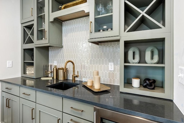 1224 Ben Forkum Dr, Lebanon, TN 37087 - kitchen featuring tasteful backsplash, dark stone counters, glass insert cabinets, wine cooler, and gray cabinets
