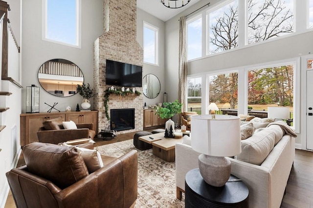 1224 Ben Forkum Dr, Lebanon, TN 37087 - living room with a towering ceiling, wood finished floors, plenty of natural light, and a fireplace