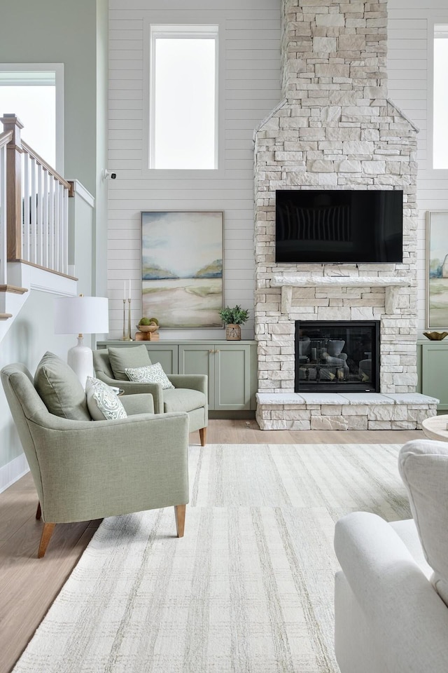 1224 Ben Forkum Dr, Lebanon, TN 37087 - living area featuring wood finished floors, a stone fireplace, and stairway