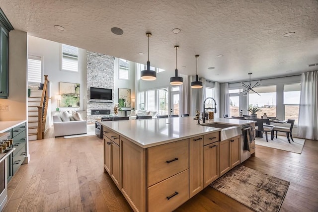 1224 Ben Forkum Dr, Lebanon, TN 37087 - kitchen featuring hardwood / wood-style flooring, open floor plan, appliances with stainless steel finishes, light countertops, and a textured ceiling
