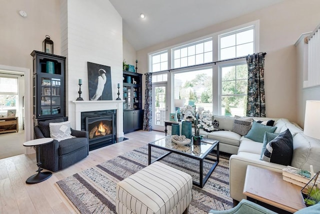 1107 Willow Springs Dr, Lebanon, TN 37087 - living room with high vaulted ceiling, plenty of natural light, wood finished floors, a fireplace with flush hearth, and recessed lighting