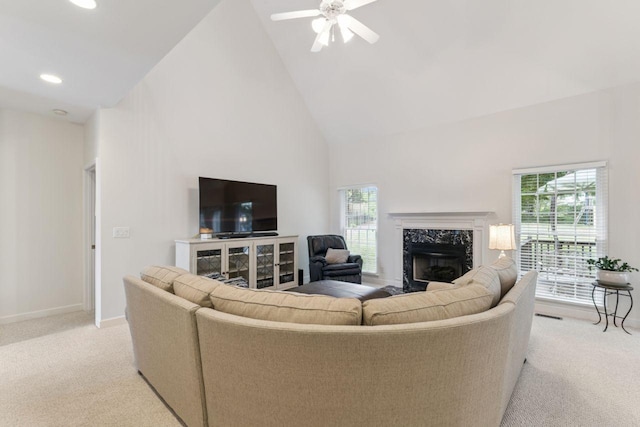 7125 Locksley Ln, Fairview, TN 37062 - living area featuring high vaulted ceiling, light colored carpet, a high end fireplace, plenty of natural light, and a ceiling fan