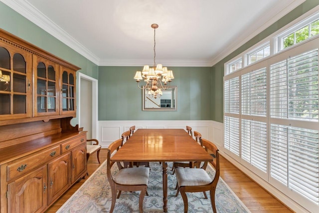 7125 Locksley Ln, Fairview, TN 37062 - dining room with a chandelier, crown molding, light wood-style flooring, wainscoting, and a decorative wall