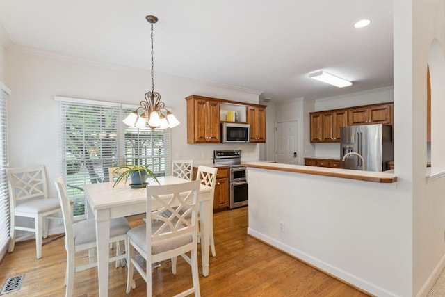 7125 Locksley Ln, Fairview, TN 37062 - dining room with a chandelier, ornamental molding, light wood-style floors, and recessed lighting