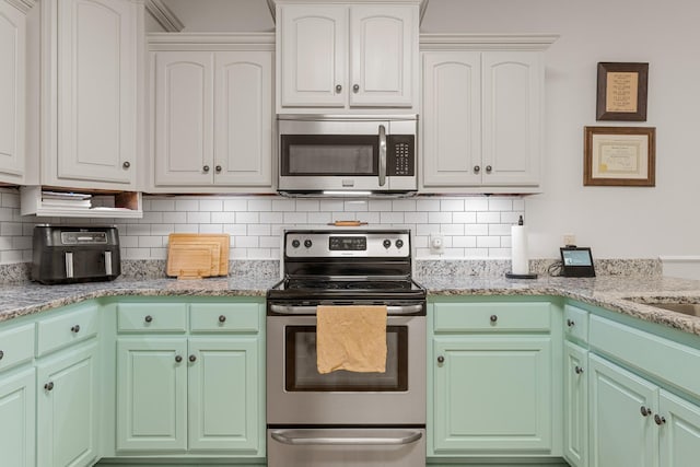 29 Harbor Pt, Lebanon, TN 37087 - kitchen featuring stainless steel appliances, backsplash, white cabinets, and light stone counters