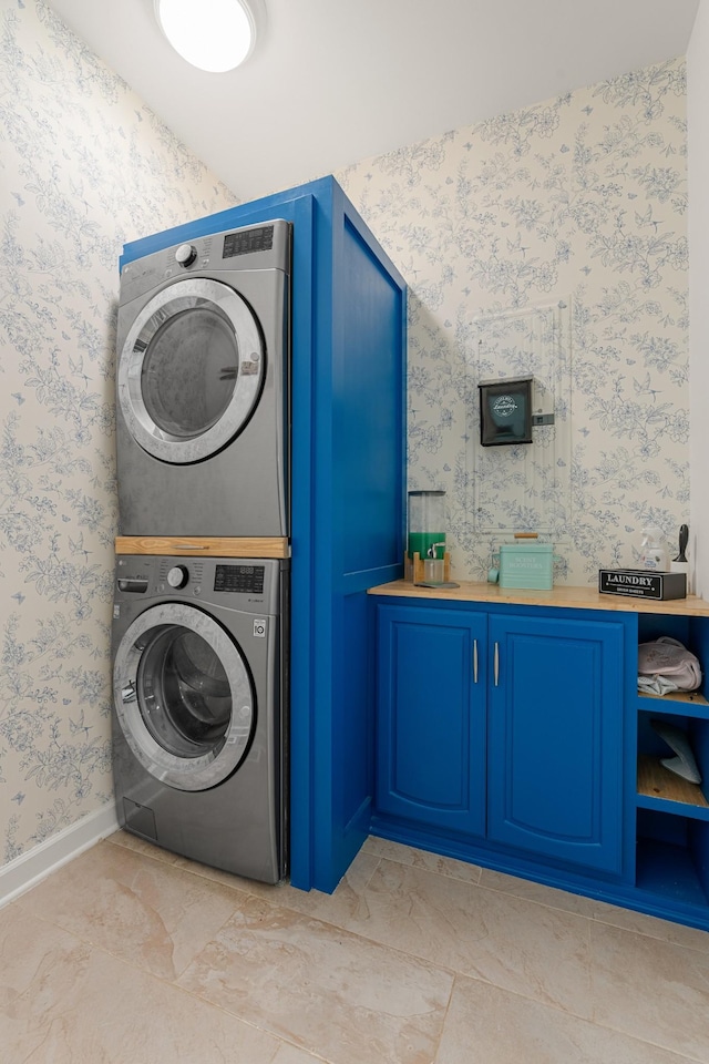 29 Harbor Pt, Lebanon, TN 37087 - washroom featuring stacked washing machine and dryer, wallpapered walls, and cabinet space