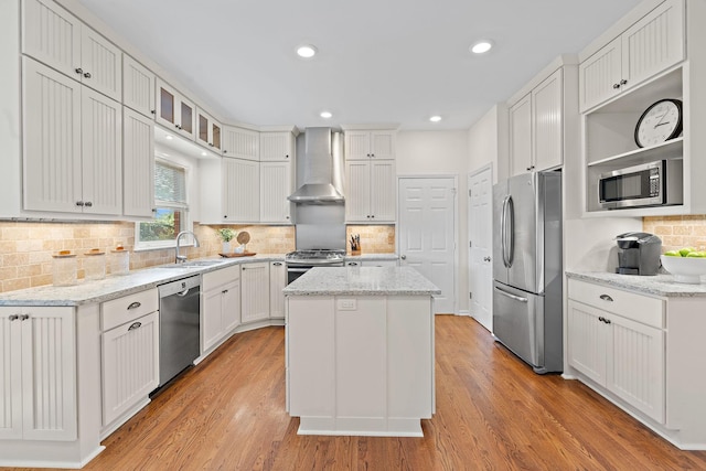 513 Foxcroft Cir, Franklin, TN 37067 - kitchen with wall chimney exhaust hood, stainless steel appliances, a center island, white cabinets, and backsplash