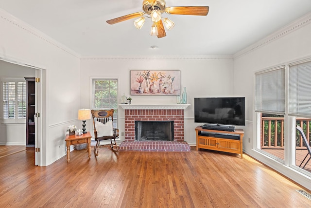 513 Foxcroft Cir, Franklin, TN 37067 - living area with wood finished floors, ceiling fan, a fireplace, and crown molding