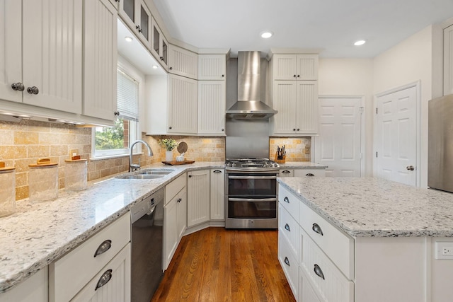 513 Foxcroft Cir, Franklin, TN 37067 - kitchen with wall chimney exhaust hood, appliances with stainless steel finishes, dark wood-style floors, light stone countertops, and glass insert cabinets