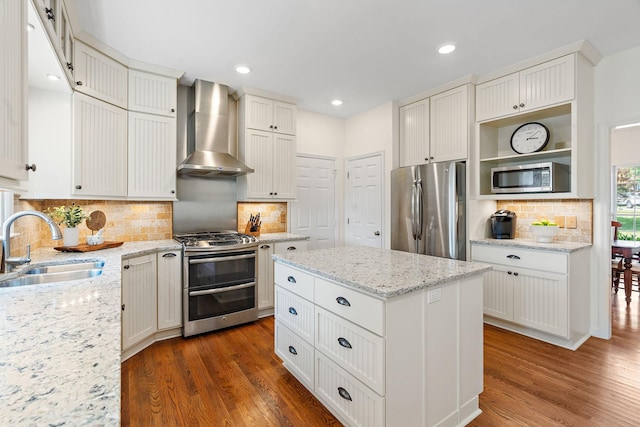 513 Foxcroft Cir, Franklin, TN 37067 - kitchen featuring stainless steel appliances, wall chimney exhaust hood, dark wood-type flooring, tasteful backsplash, and recessed lighting