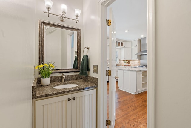 513 Foxcroft Cir, Franklin, TN 37067 - bathroom featuring vanity, tasteful backsplash, wood finished floors, and recessed lighting