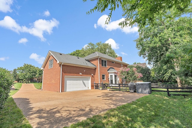513 Foxcroft Cir, Franklin, TN 37067 - view of front facade with brick siding, driveway, a garage, and a chimney