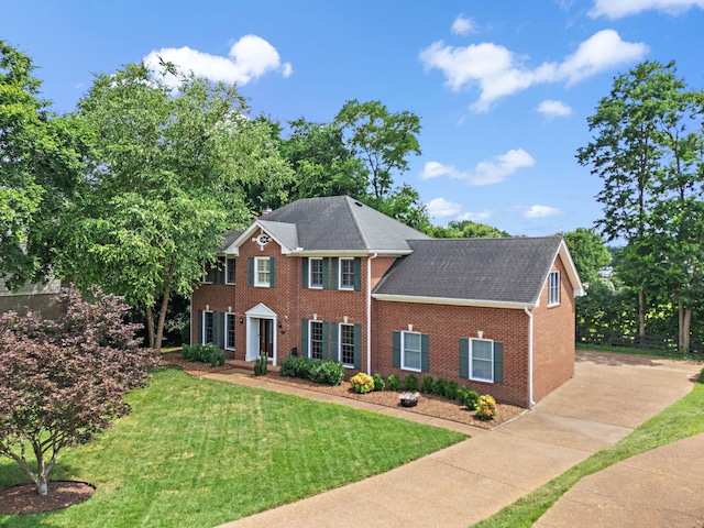 513 Foxcroft Cir, Franklin, TN 37067 - colonial house with brick siding, a front yard, and a shingled roof