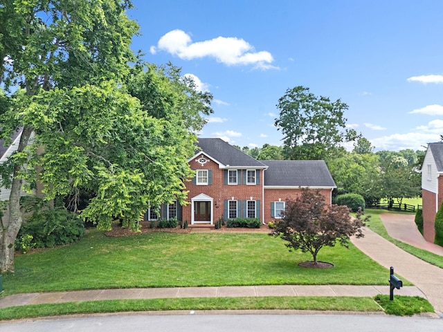 513 Foxcroft Cir, Franklin, TN 37067 - colonial house featuring brick siding and a front lawn