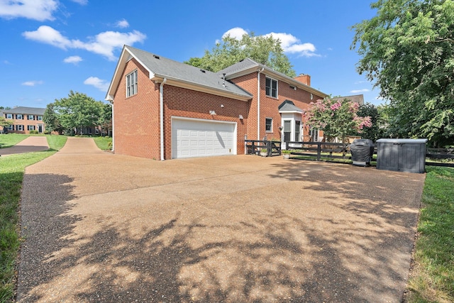 513 Foxcroft Cir, Franklin, TN 37067 - view of front of home featuring brick siding, driveway, and a chimney