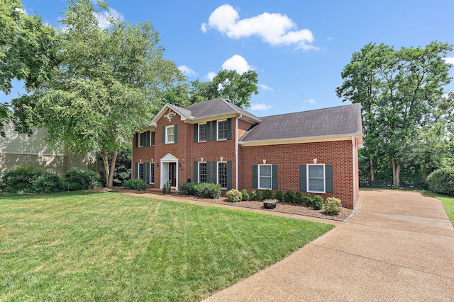 513 Foxcroft Cir, Franklin, TN 37067 - colonial-style house featuring brick siding, a front lawn, driveway, and roof with shingles