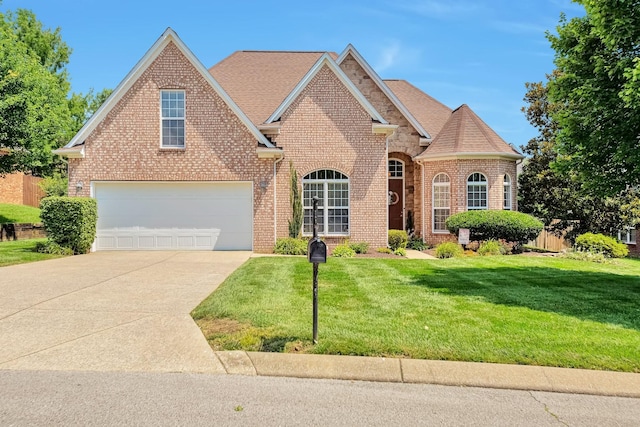 3045 Sakari Cir, Spring Hill, TN 37174 - traditional home with brick siding, concrete driveway, a front yard, a shingled roof, and a garage