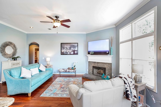 3045 Sakari Cir, Spring Hill, TN 37174 - living area with arched walkways, ceiling fan, wood finished floors, crown molding, and a stone fireplace
