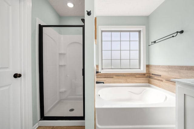 2210 Indian Mound Rd, Woodlawn, TN 37191 - full bath featuring a stall shower, a bath, a textured ceiling, and vanity