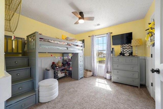 2210 Indian Mound Rd, Woodlawn, TN 37191 - bedroom with a textured ceiling, carpet, a wainscoted wall, and a ceiling fan