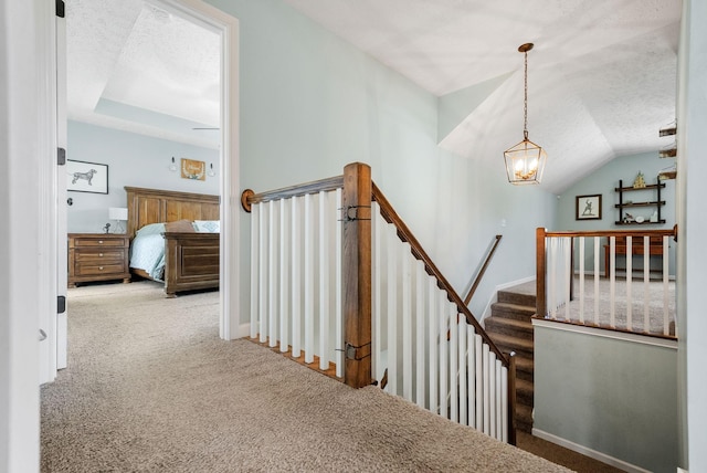 2210 Indian Mound Rd, Woodlawn, TN 37191 - hall with an upstairs landing, carpet, a textured ceiling, and a chandelier