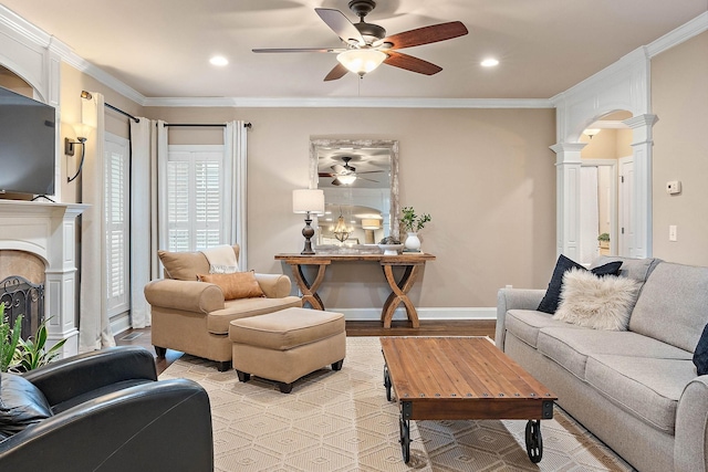 1011 Glessner Dr, Spring Hill, TN 37174 - living room featuring a ceiling fan, ornate columns, arched walkways, a fireplace, and ornamental molding