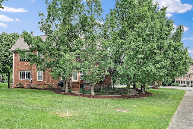 1011 Glessner Dr, Spring Hill, TN 37174 - view of front of property featuring a front lawn, brick siding, a wooden deck, and crawl space