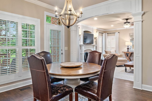 1011 Glessner Dr, Spring Hill, TN 37174 - dining area with ornate columns, crown molding, a fireplace, dark wood-style flooring, and a chandelier