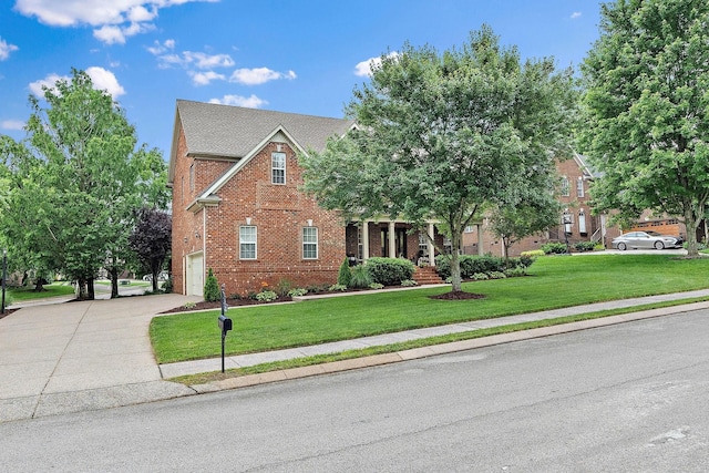 1011 Glessner Dr, Spring Hill, TN 37174 - view of front of home with brick siding, driveway, a garage, and a front yard