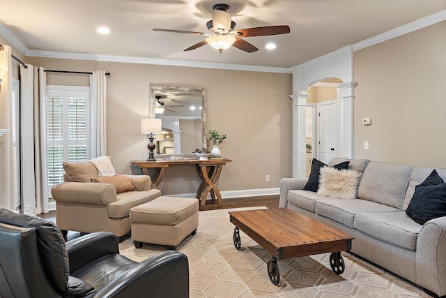 1011 Glessner Dr, Spring Hill, TN 37174 - living room with decorative columns, a ceiling fan, light wood-style flooring, ornamental molding, and arched walkways