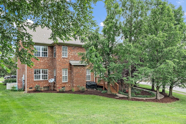 1011 Glessner Dr, Spring Hill, TN 37174 - back of property featuring brick siding, a lawn, and roof with shingles