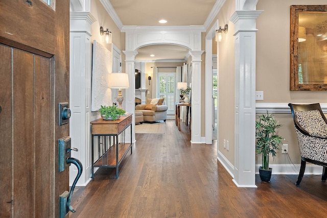 1011 Glessner Dr, Spring Hill, TN 37174 - foyer entrance with ornate columns, crown molding, arched walkways, dark wood-style floors, and recessed lighting
