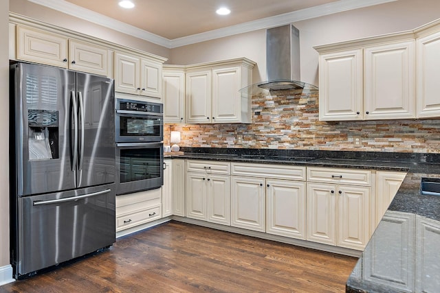 1011 Glessner Dr, Spring Hill, TN 37174 - kitchen featuring appliances with stainless steel finishes, wall chimney range hood, ornamental molding, dark wood-style floors, and dark stone counters