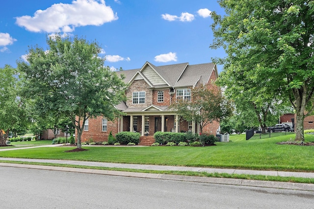 1011 Glessner Dr, Spring Hill, TN 37174 - craftsman house featuring a front yard, brick siding, and covered porch