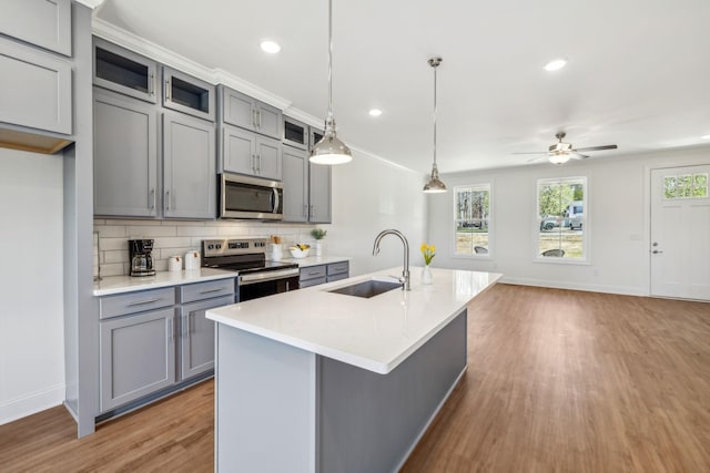1894 Hamilton Chambers Rd, Lebanon, TN 37087 - kitchen featuring appliances with stainless steel finishes, gray cabinetry, light wood finished floors, backsplash, and recessed lighting