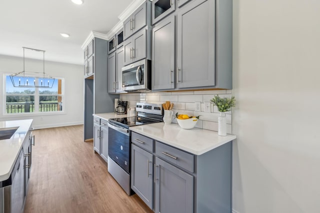 1894 Hamilton Chambers Rd, Lebanon, TN 37087 - kitchen with stainless steel appliances, gray cabinetry, backsplash, light countertops, and recessed lighting