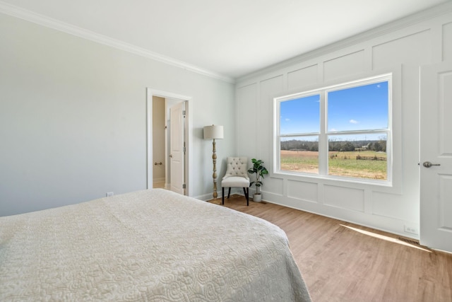 1894 Hamilton Chambers Rd, Lebanon, TN 37087 - bedroom featuring ornamental molding, light wood-type flooring, and a decorative wall