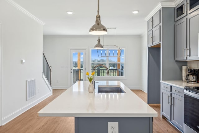 1894 Hamilton Chambers Rd, Lebanon, TN 37087 - kitchen with gray cabinetry, stainless steel electric stove, light wood-style floors, crown molding, and recessed lighting