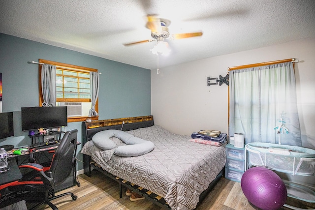 190 Blackwell Dr, Hohenwald, TN 38462 - bedroom featuring cooling unit, wood finished floors, a textured ceiling, a desk, and ceiling fan
