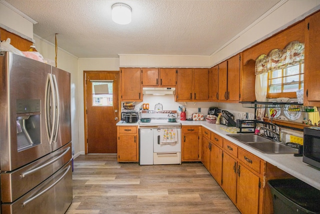 190 Blackwell Dr, Hohenwald, TN 38462 - kitchen with appliances with stainless steel finishes, under cabinet range hood, a textured ceiling, light countertops, and light wood-style floors