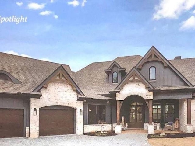 25 Shoreview Ln, Huntingdon, TN 38344 - french country home featuring stone siding, an attached garage, and roof with shingles