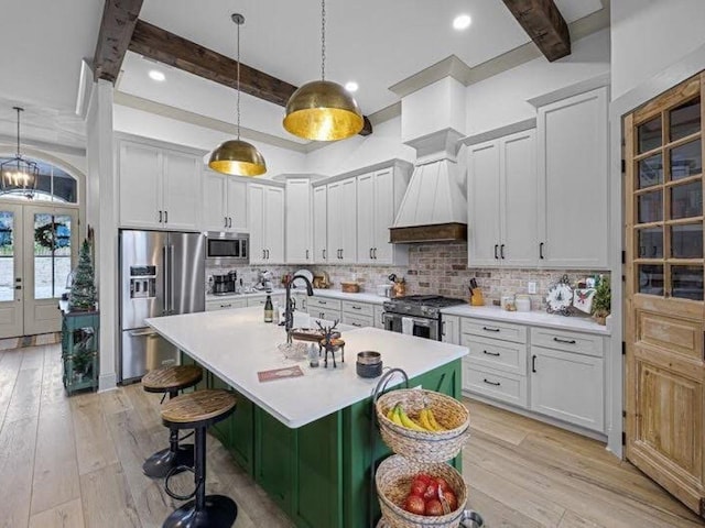 25 Shoreview Ln, Huntingdon, TN 38344 - kitchen featuring stainless steel appliances, a kitchen breakfast bar, beam ceiling, light countertops, and decorative backsplash