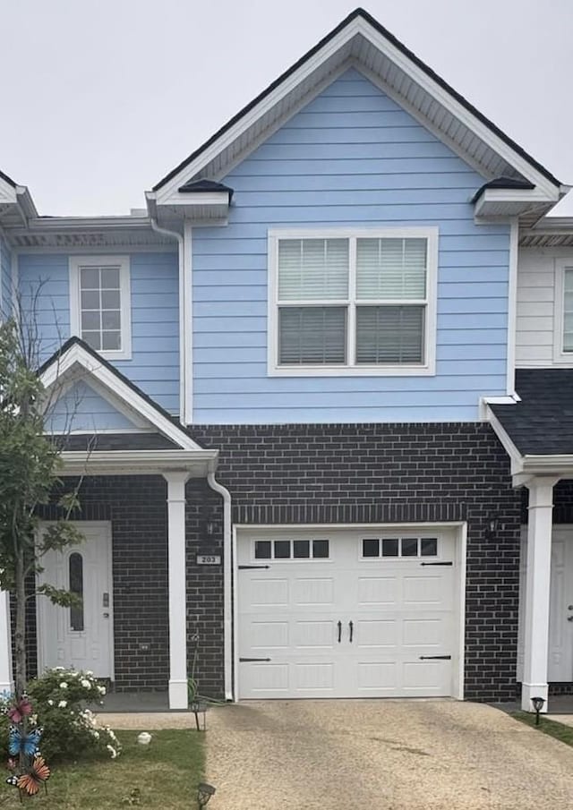 203 Longfellow Ln, Smyrna, TN 37167 - view of front facade featuring an attached garage, brick siding, and concrete driveway